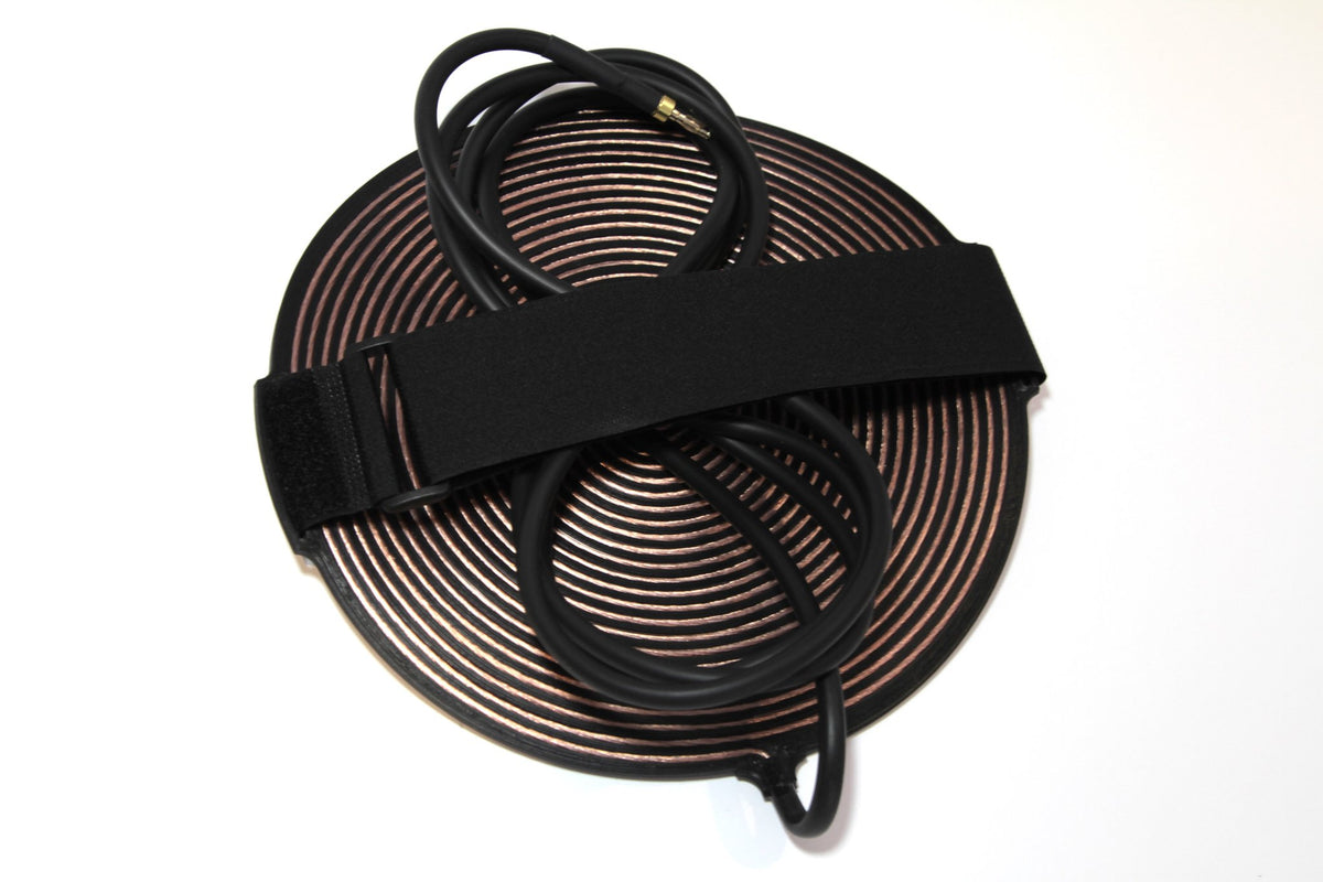Gandr coil with the elastic strap fitted through the outer grooves, ready to be strapped to a limb