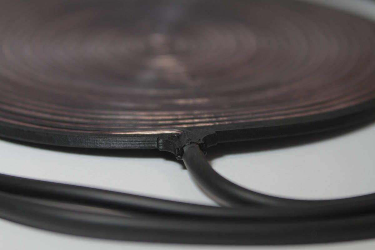 Close-up of the Gandr coil edge showing the 5 mm profile and the moulded cable exit point