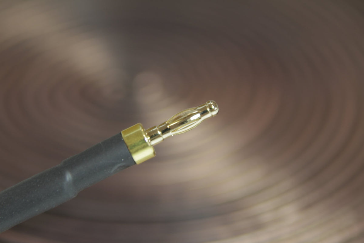 Gold-plated banana plug terminated on the black accessory lead cable
