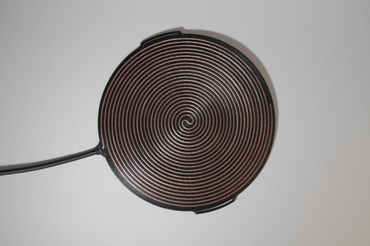 Gandr bifilar pancake coil photographed at an angle with the full lead cable laid out