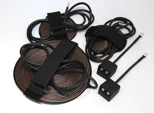 Overhead view of the full kit laid out: coils, pads, connection boxes and ring terminal leads